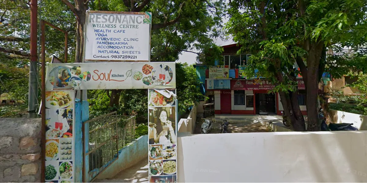 Soul Kitchen signs at the leafy entrance to Resonance Wellness Centre in Rishikesh