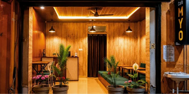 Warm wooden interiors and plants at Cafe MYO in Rishikesh