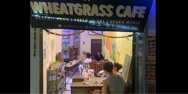 Wheatgrass Cafe entrance with a sign for organic food, fresh juices and vegan meals